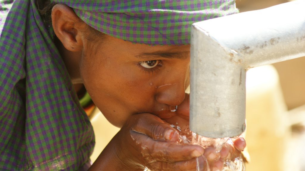 Woman drinking pumped water.